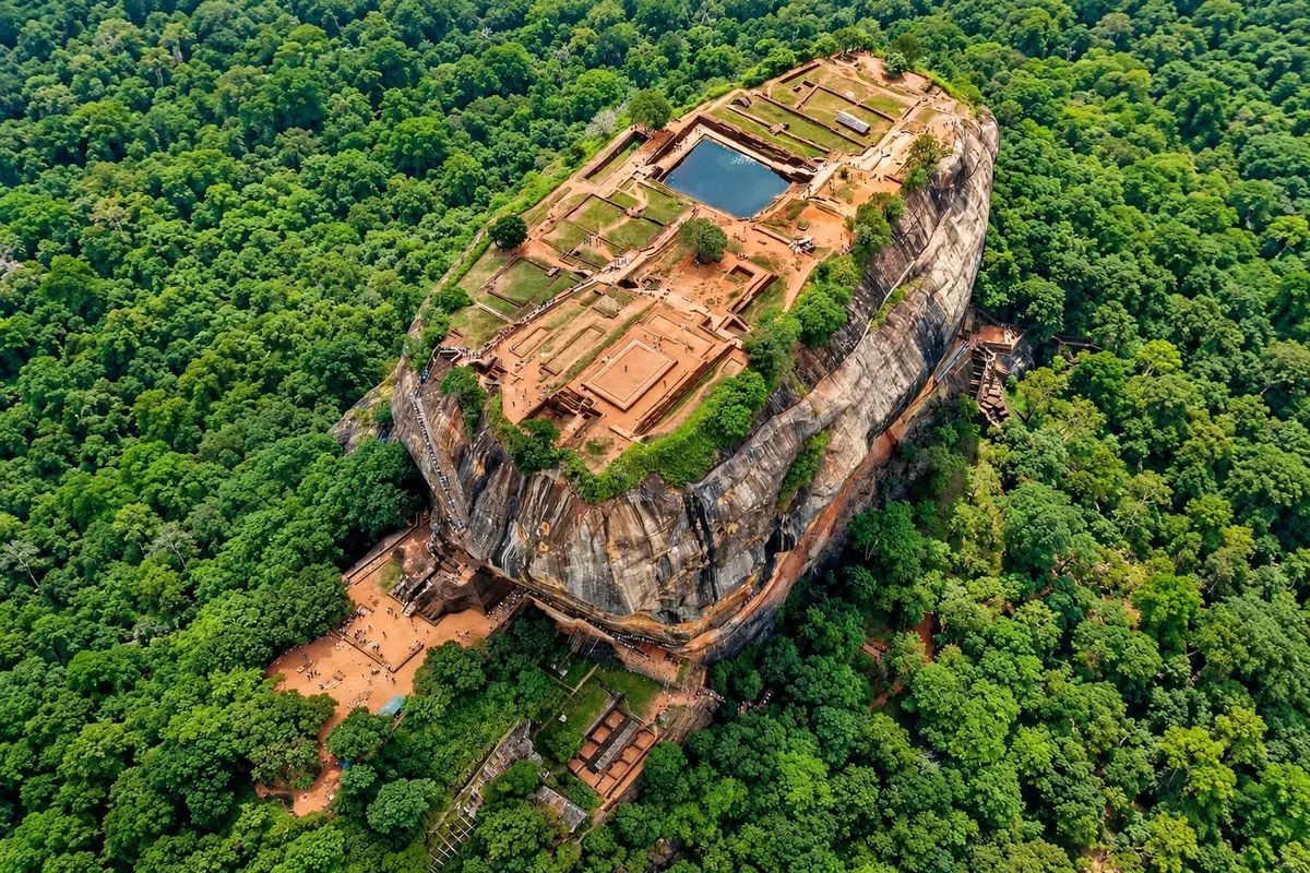 Aerial view of the palace remains and pools on Sigiriya surrounded by forest