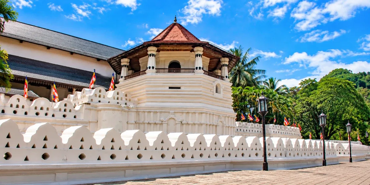 Temple of the Tooth in Kandy beneath a blue sky